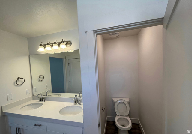 7303 North Hidden Loop Road Eagle Mountain, UT 84005 - Photo 7 of 11 Dual vanity with undermount sinks, single-handle faucets, and a large mirror