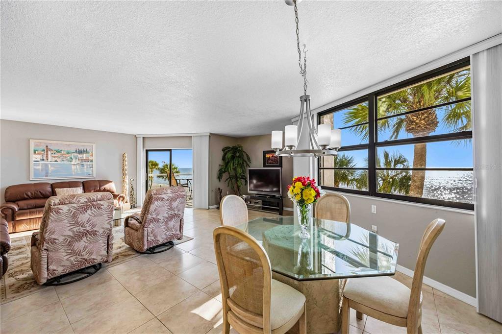 1050 Longboat Club Road, Unit 301 Longboat Key, FL 34228 - Photo 11 of 57 a dining room with furniture window and wooden floor