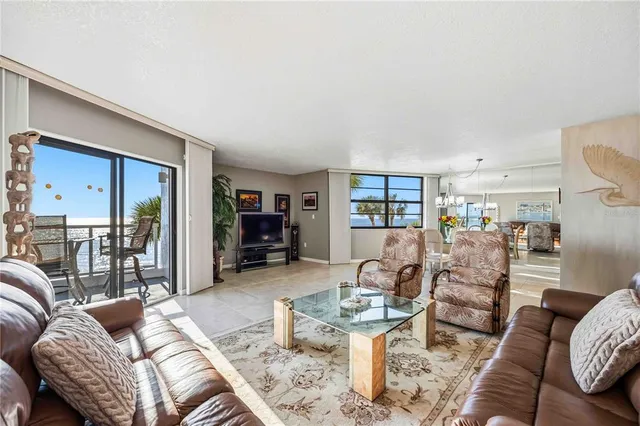 a dining room with furniture and a chandelier