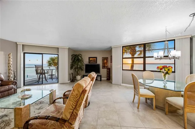 a bedroom with a bed a table and a large window