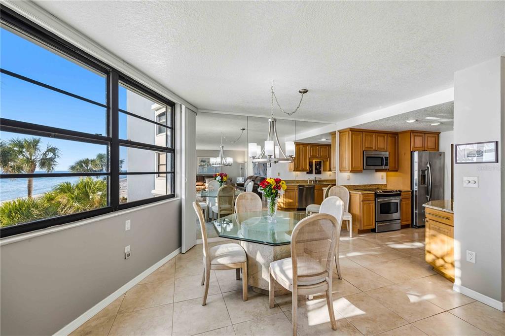 1050 Longboat Club Road, Unit 301 Longboat Key, FL 34228 - Photo 18 of 57 a view of a dining room with furniture window and outside view