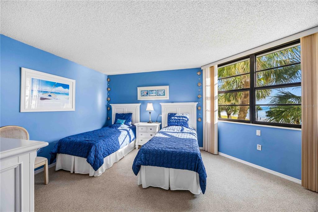 1050 Longboat Club Road, Unit 301 Longboat Key, FL 34228 - Photo 25 of 57 a spacious bedroom with two beds and a large window