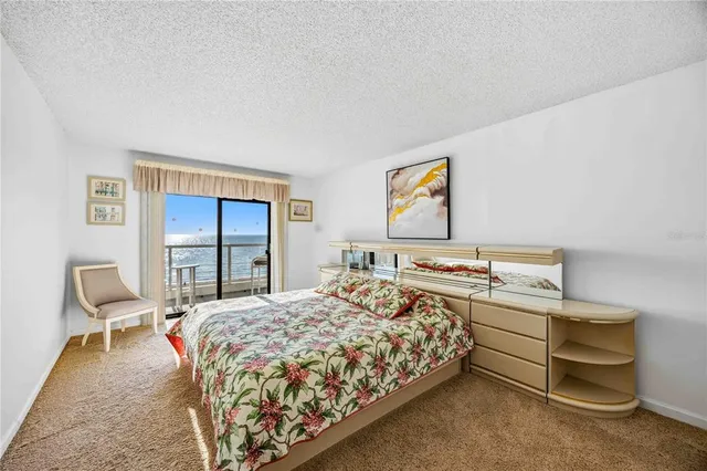 a bed sitting in a bedroom and a table