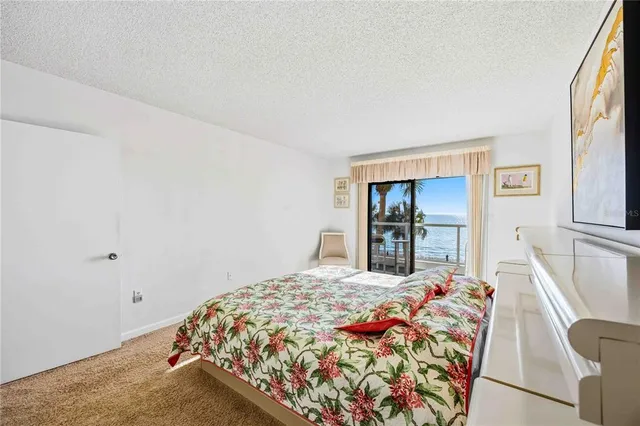 a bathroom with a granite countertop sink a toilet a mirror and shower