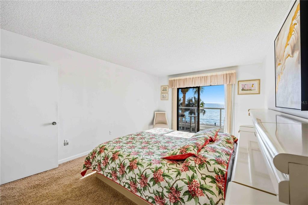 1050 Longboat Club Road, Unit 301 Longboat Key, FL 34228 - Photo 29 of 57 a bedroom with a bed and a large mirror on dresser