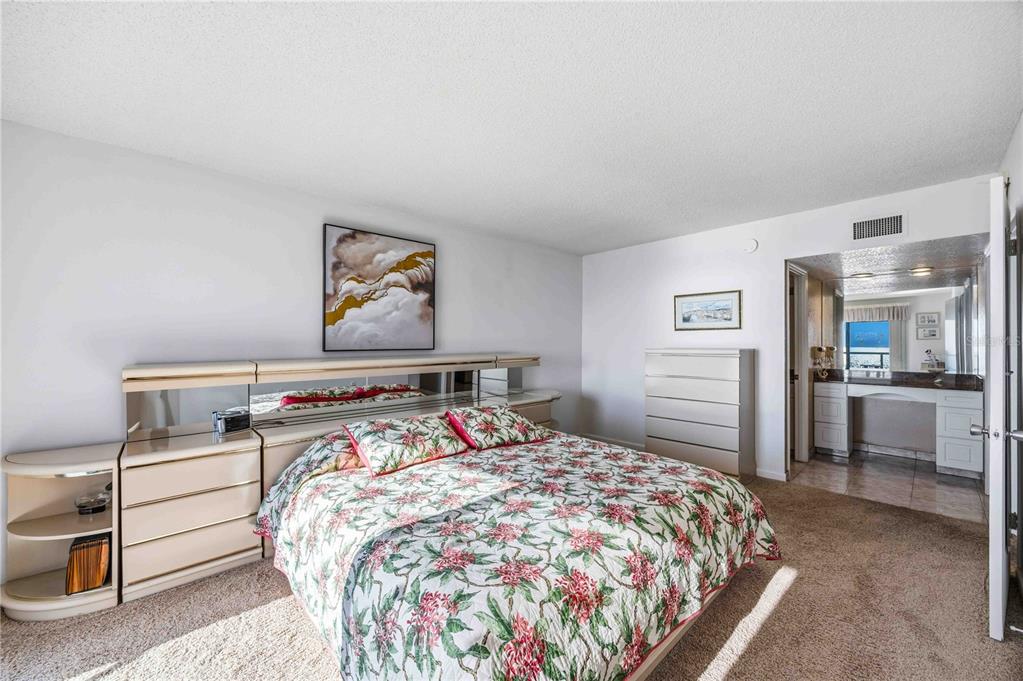 1050 Longboat Club Road, Unit 301 Longboat Key, FL 34228 - Photo 31 of 57 a bed sitting in a bedroom and a table