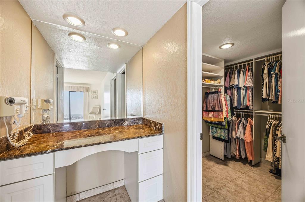 1050 Longboat Club Road, Unit 301 Longboat Key, FL 34228 - Photo 33 of 57 a bathroom with a sink and a large mirror