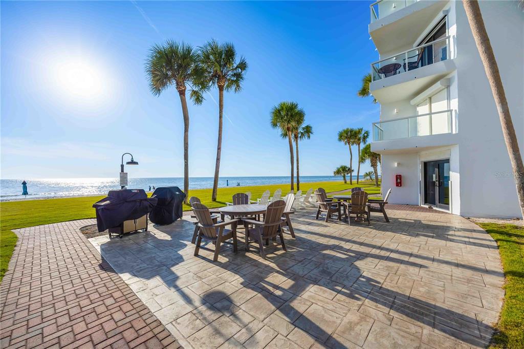 1050 Longboat Club Road, Unit 301 Longboat Key, FL 34228 - Photo 40 of 57 a view of a swimming pool with a table and chairs