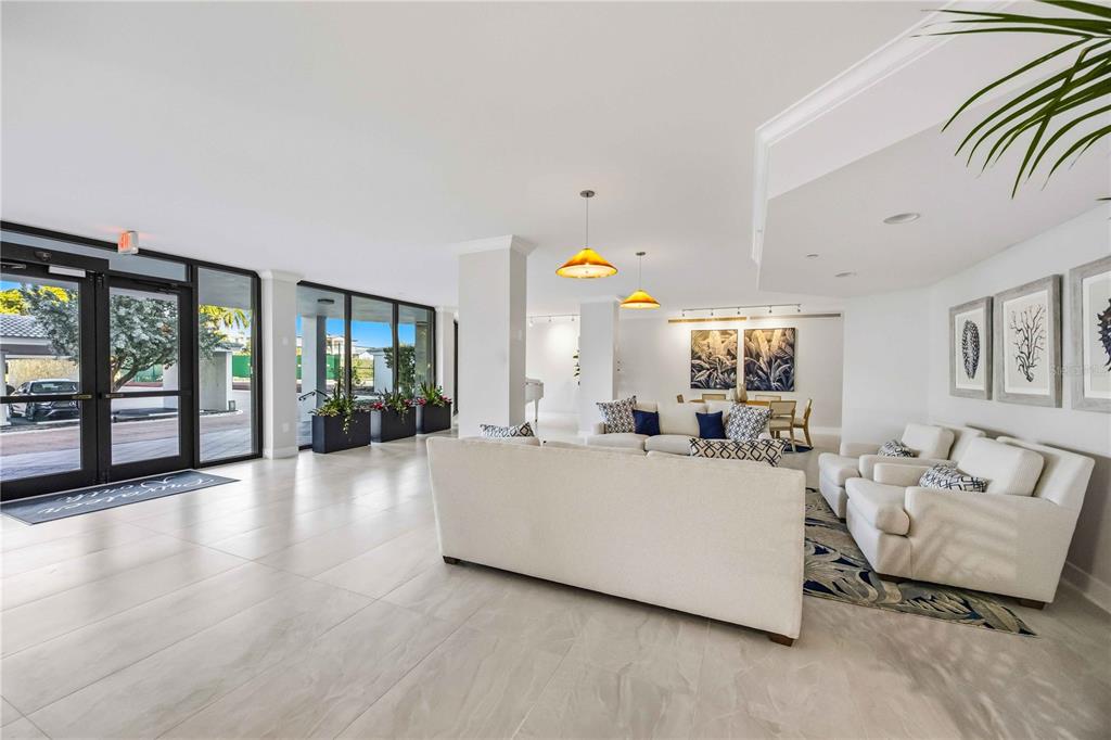 1050 Longboat Club Road, Unit 301 Longboat Key, FL 34228 - Photo 4 of 57 a living room with furniture and large windows