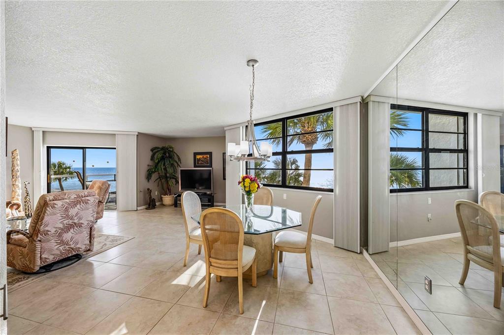 1050 Longboat Club Road, Unit 301 Longboat Key, FL 34228 - Photo 7 of 57 a dining room with furniture and window