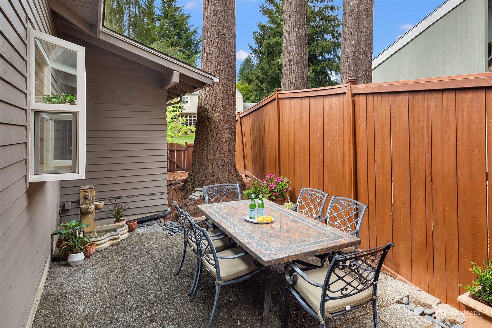 4448 144th Avenue Southeast Bellevue, WA 98006 - Photo 18 of 40 a backyard of a house with table and chairs
