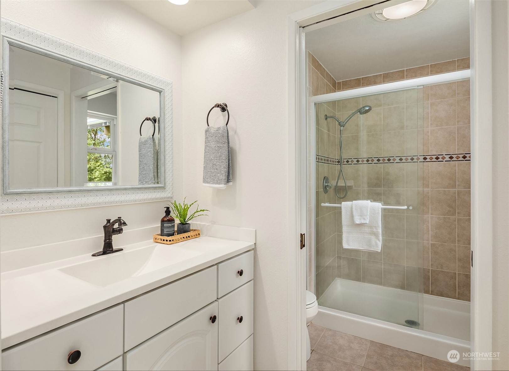 4448 144th Avenue Southeast Bellevue, WA 98006 - Photo 20 of 40 a bathroom with a shower sink and mirror