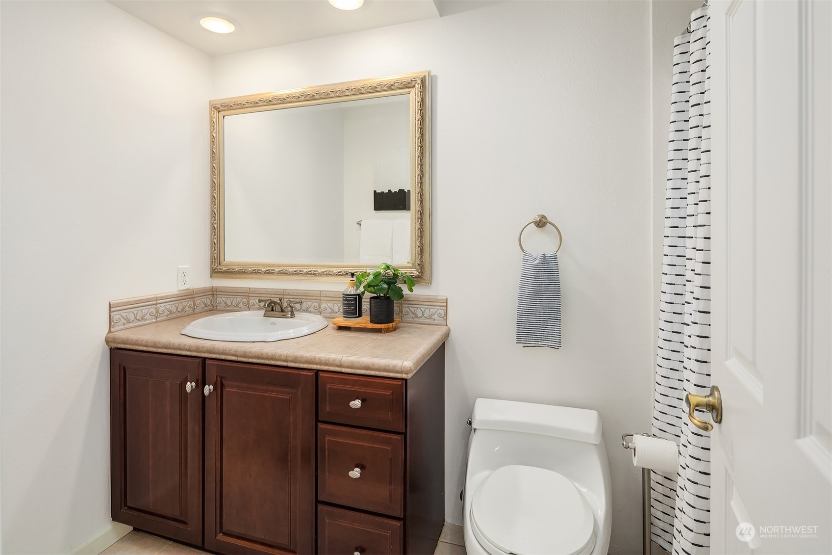4448 144th Avenue Southeast Bellevue, WA 98006 - Photo 22 of 40 a bathroom with a granite countertop sink and a mirror