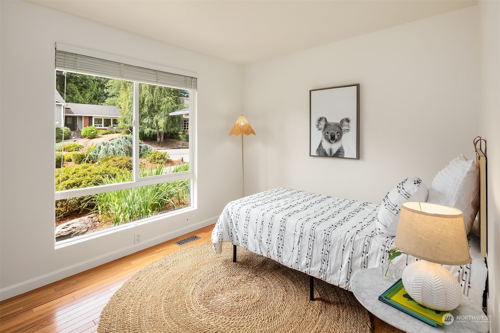 4448 144th Avenue Southeast Bellevue, WA 98006 - Photo 23 of 40 a bedroom with a bed and glass window