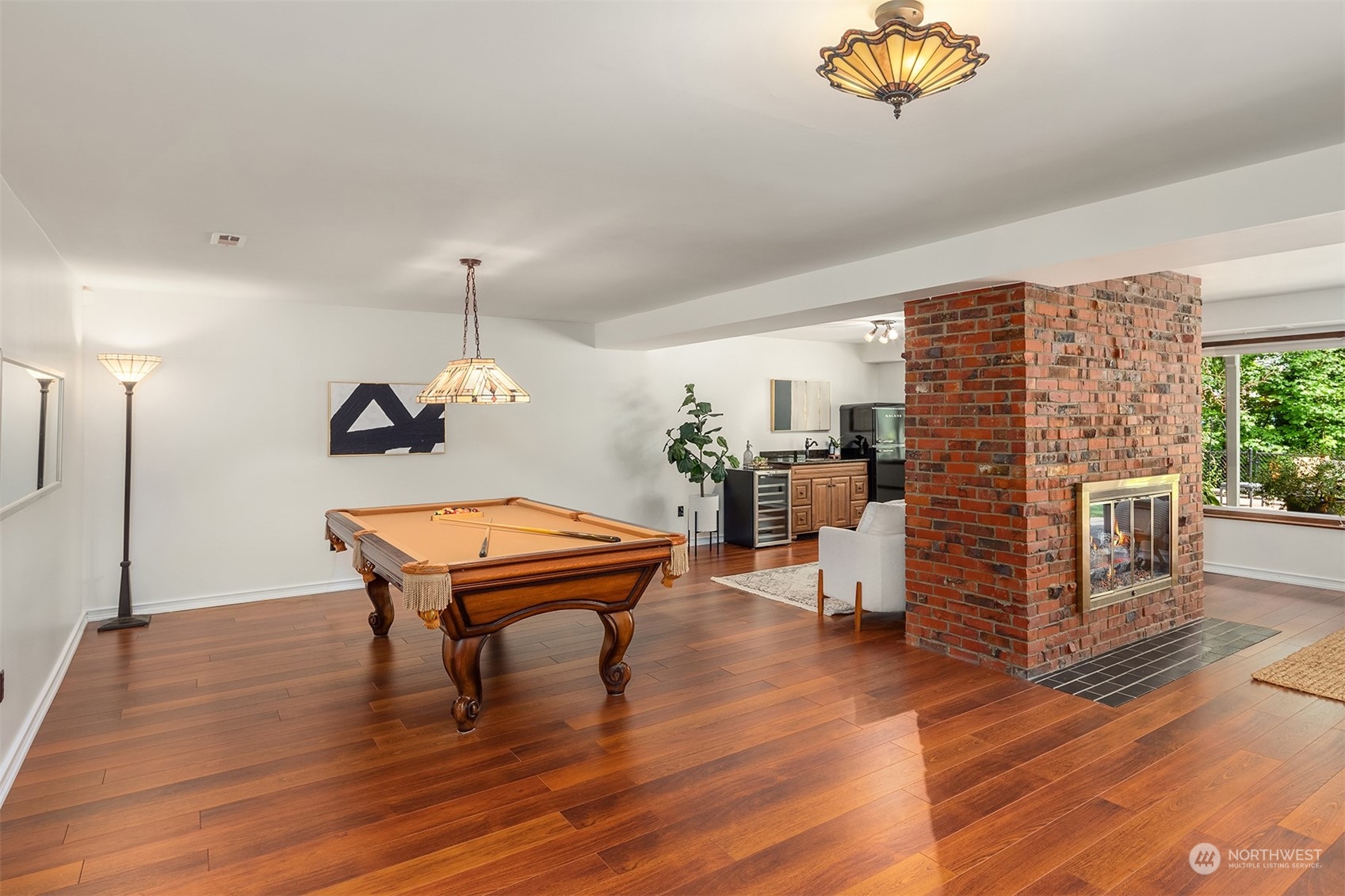 4448 144th Avenue Southeast Bellevue, WA 98006 - Photo 24 of 40 a room with wooden floors table and chairs
