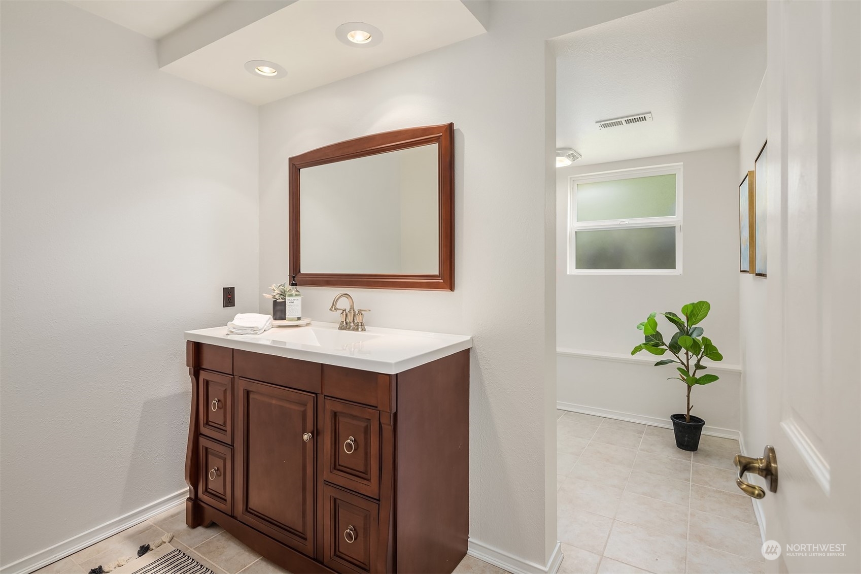 4448 144th Avenue Southeast Bellevue, WA 98006 - Photo 30 of 40 a bathroom with a sink a vanity and a mirror