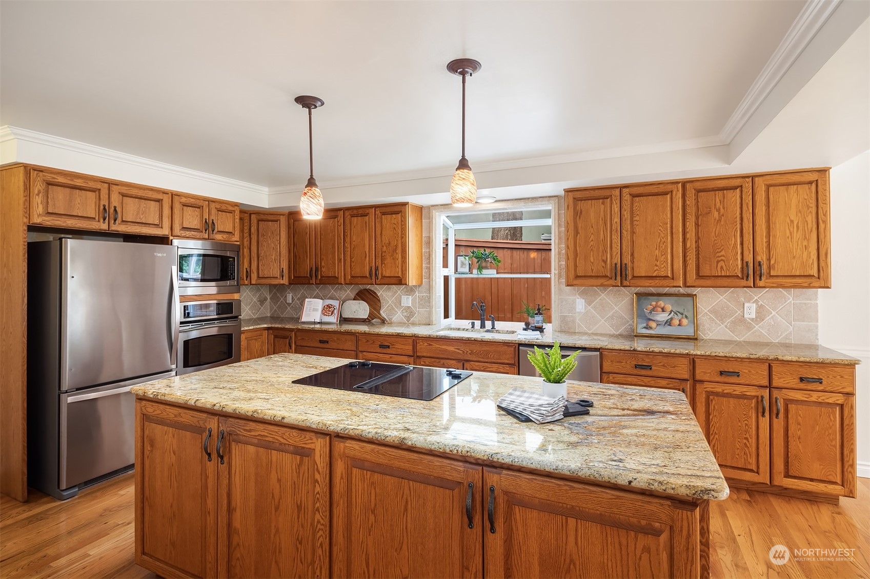 4448 144th Avenue Southeast Bellevue, WA 98006 - Photo 8 of 40 a kitchen with stainless steel appliances granite countertop a sink refrigerator and cabinets