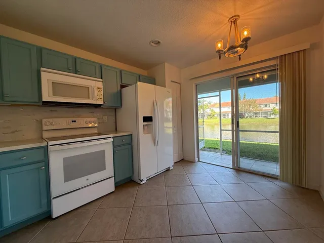a kitchen with a stove a fridge and a sink