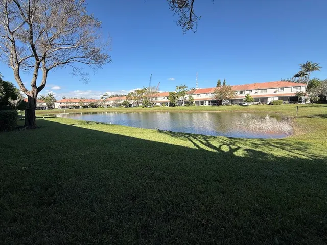 a view of a lake with houses in the background