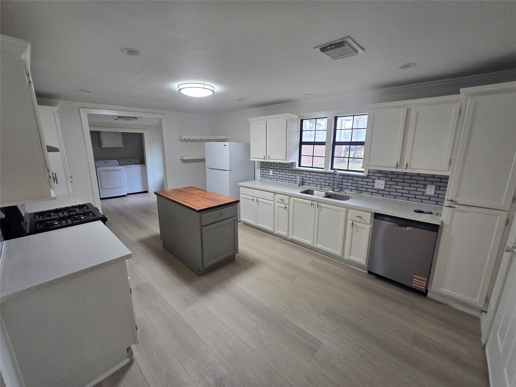 9254 Haddick Street Houston, TX 77028 - Photo 11 of 18 a large kitchen with stainless steel appliances granite countertop a stove a sink dishwasher and a refrigerator