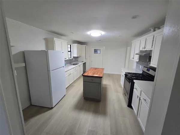 a kitchen with a refrigerator a sink and dishwasher