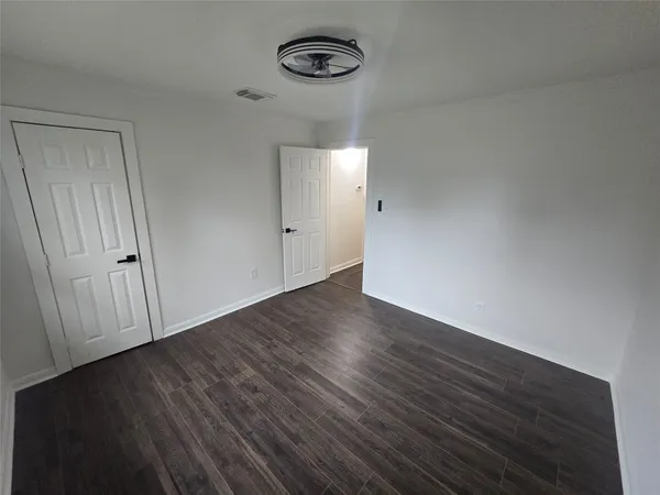 a view of a room with wooden floor