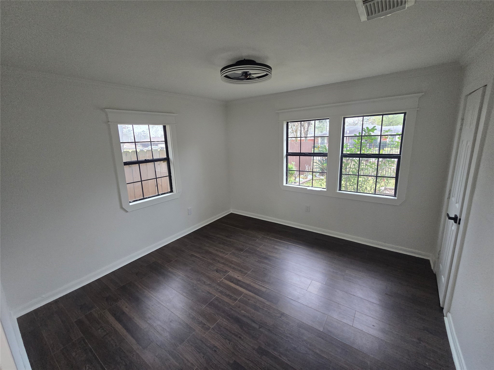 9254 Haddick Street Houston, TX 77028 - Photo 18 of 18 an empty room with wooden floor and windows