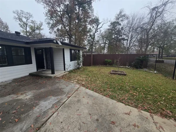 a backyard of a house with lots of green space