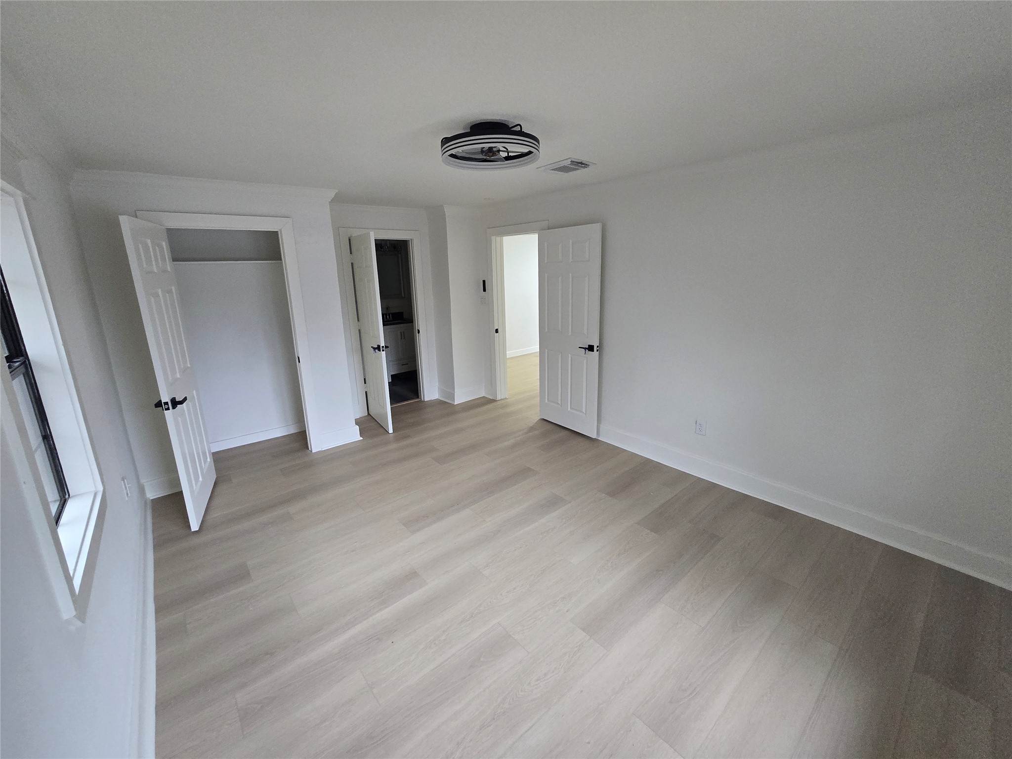 9254 Haddick Street Houston, TX 77028 - Photo 6 of 18 an empty room with wooden floor and windows