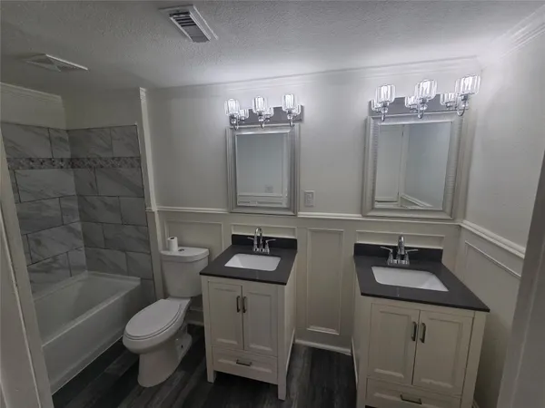 a bathroom with a toilet a sink and bathtub
