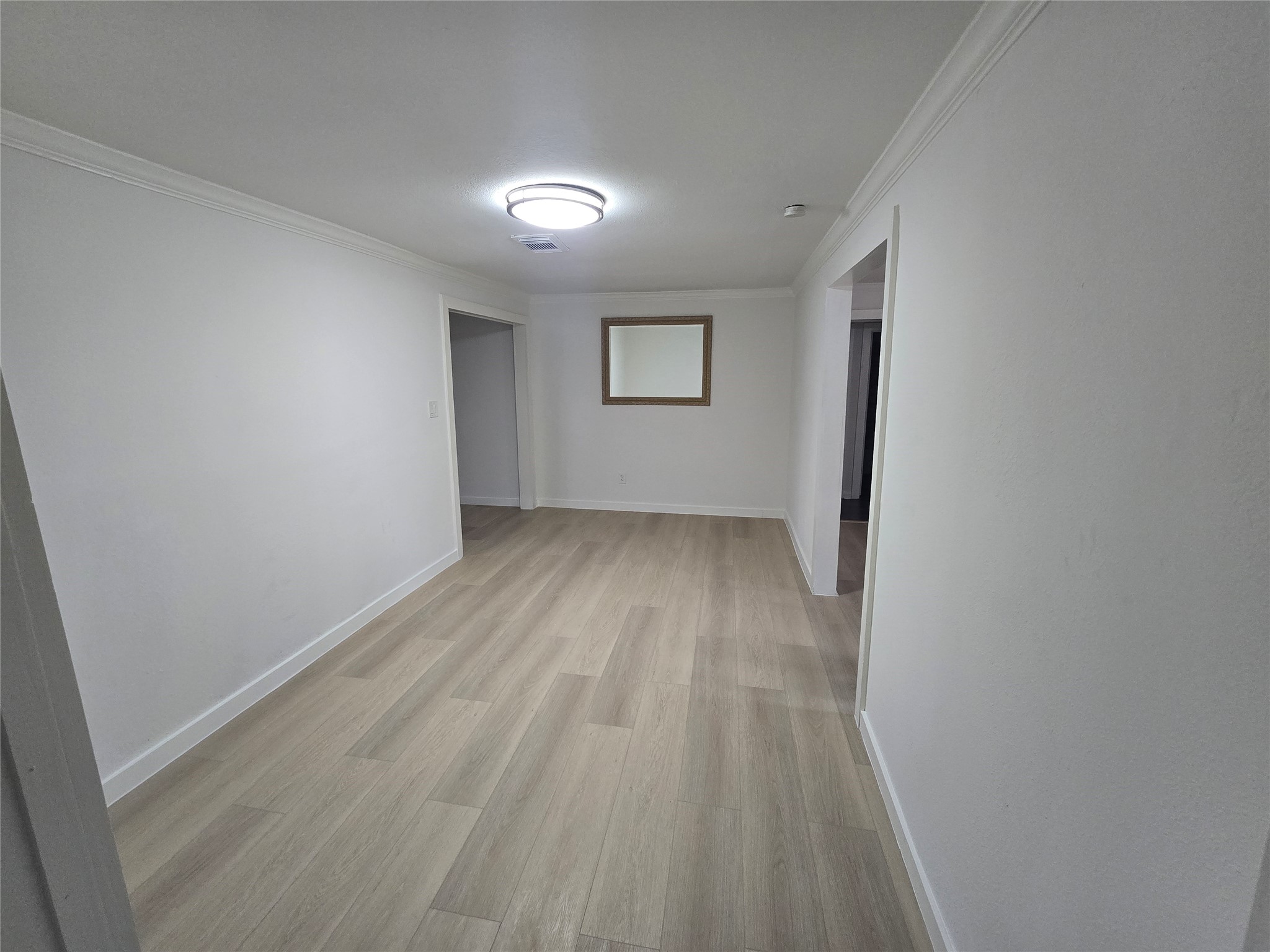 9254 Haddick Street Houston, TX 77028 - Photo 10 of 18 an empty room with wooden floor and windows