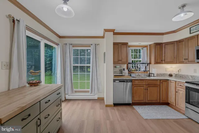 a kitchen with stainless steel appliances granite countertop a stove and a sink