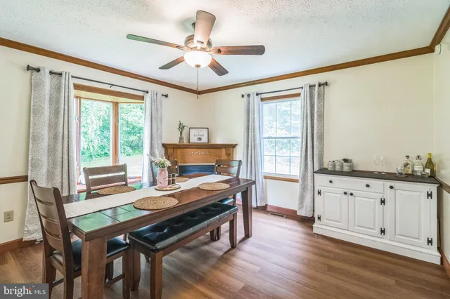 a living room with furniture a fireplace and a window