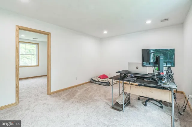 a room with gym equipment and view of living room