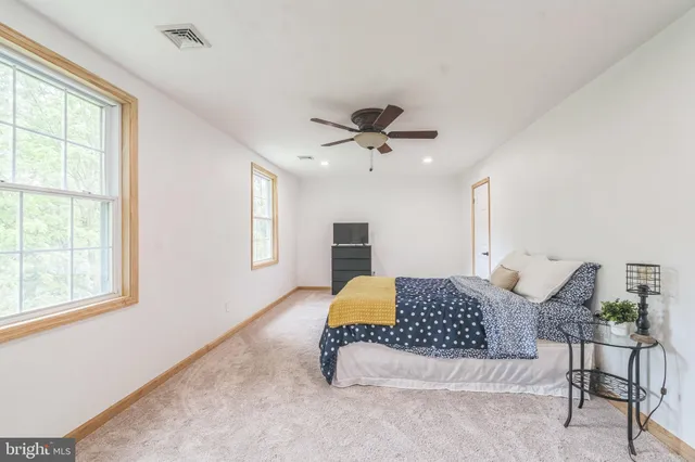 a bedroom with a large bed and a window