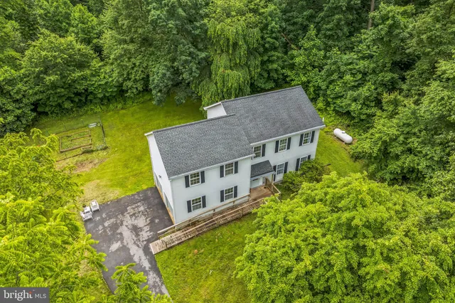 a aerial view of a house with swimming pool next to a yard