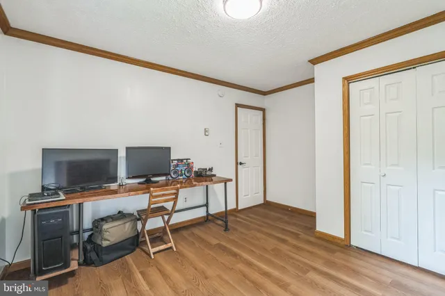 a view of a workspace with furniture and wooden floor