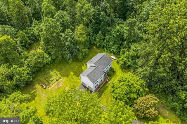 an aerial view of a house with a yard