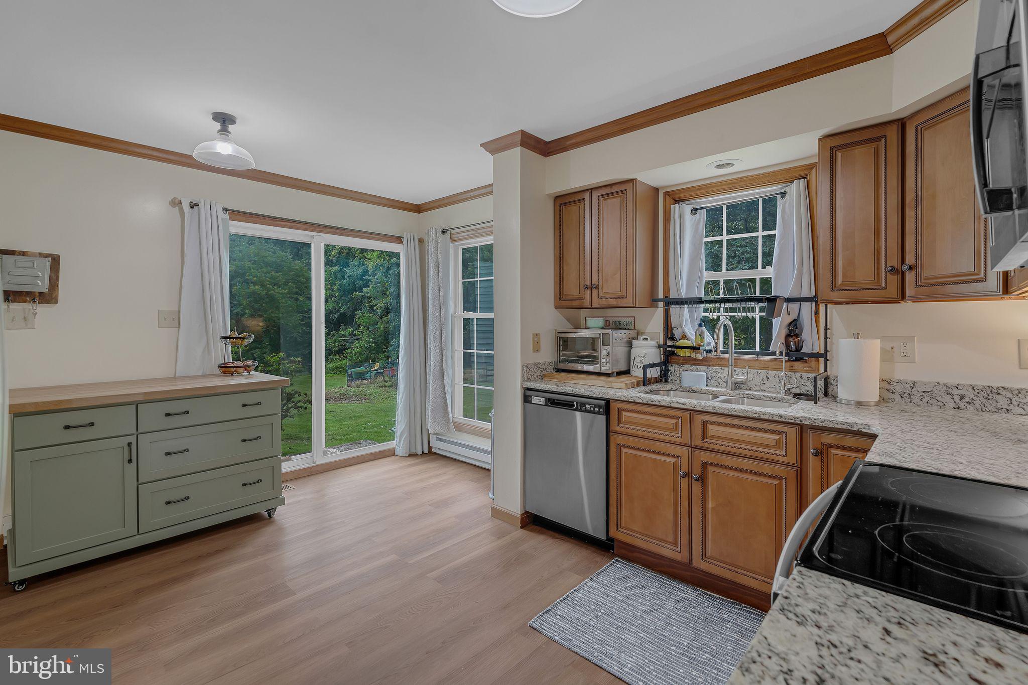 17 Oaklawn Drive Parkesburg, PA 19365 - Photo 8 of 45 a kitchen with granite countertop a stove a sink and a refrigerator