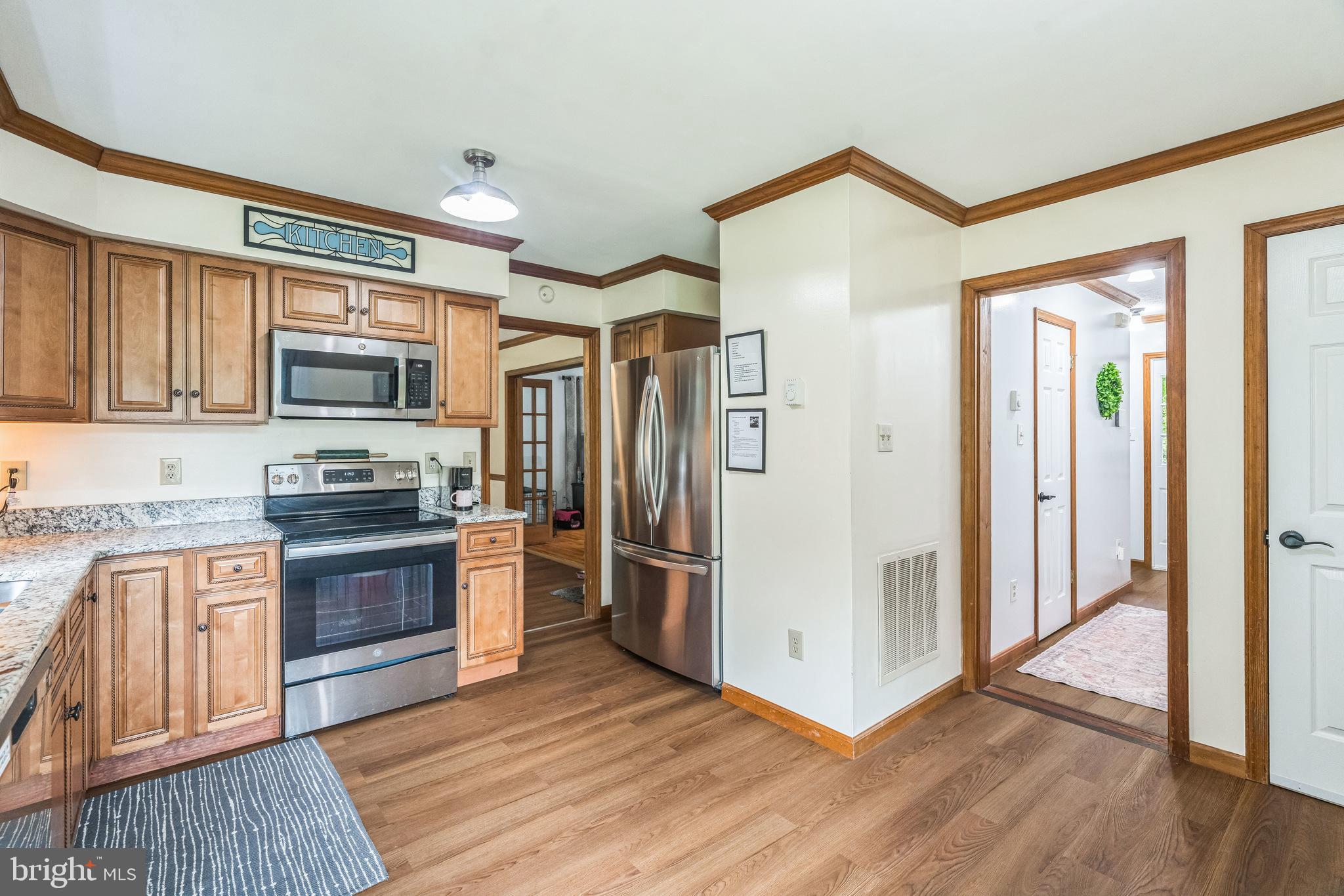 17 Oaklawn Drive Parkesburg, PA 19365 - Photo 9 of 45 a kitchen with stainless steel appliances granite countertop a refrigerator and a stove top oven