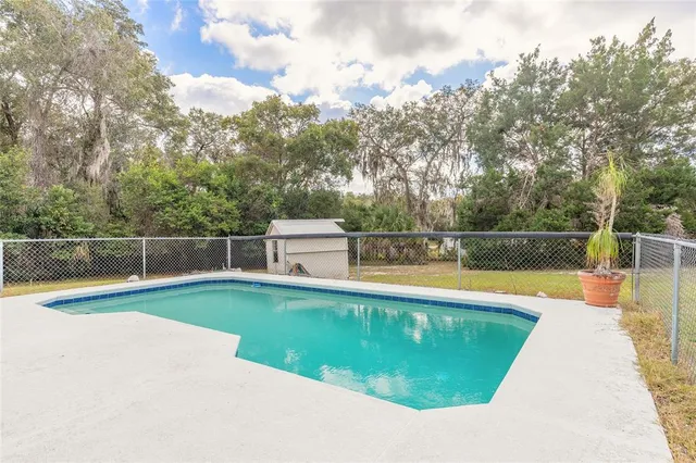 a view of a house with swimming pool and porch with furniture