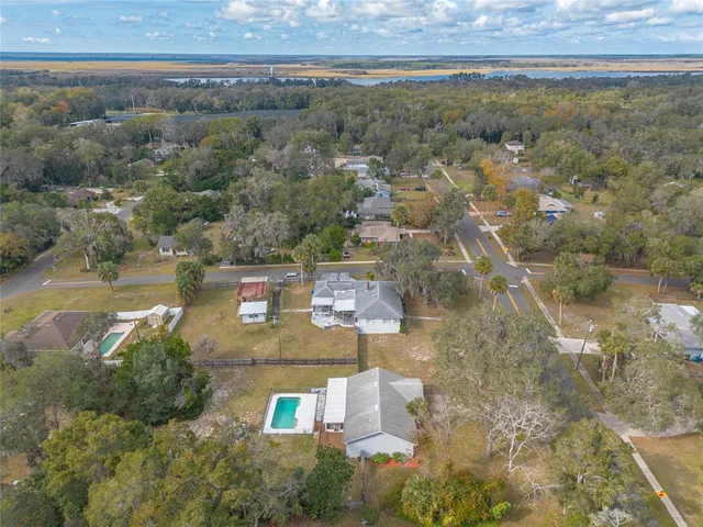 an aerial view of a house with a yard