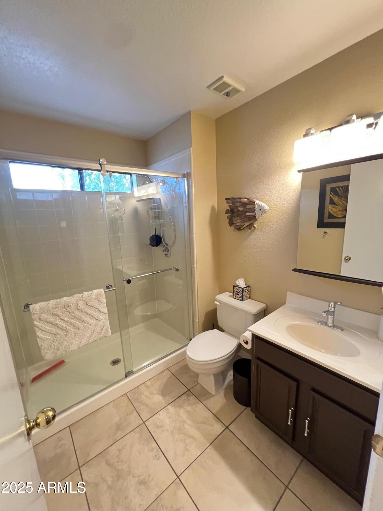 5518 East Lindstrom Lane, Unit 2020 Mesa, AZ 85215 - Photo 12 of 35 a bathroom with a sink toilet and shower