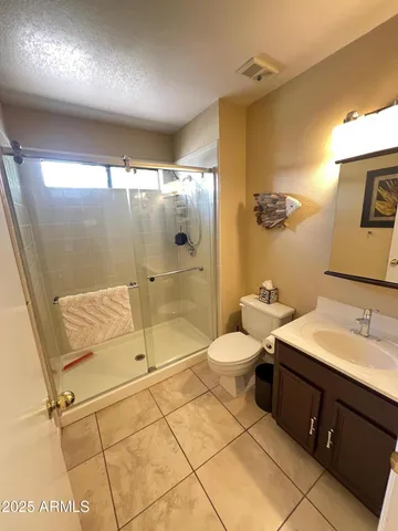 a bathroom with a sink mirror toilet and shower