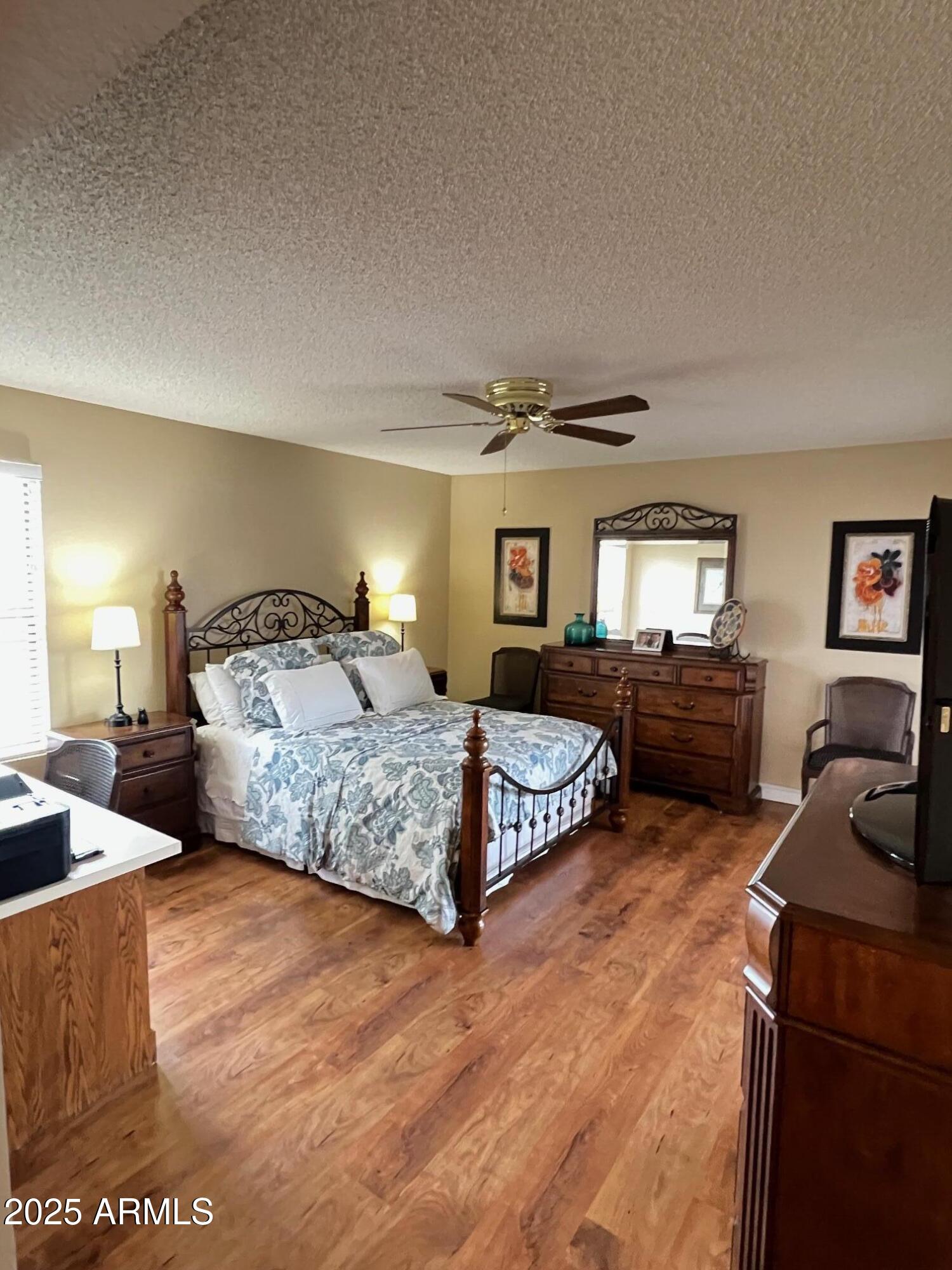 5518 East Lindstrom Lane, Unit 2020 Mesa, AZ 85215 - Photo 15 of 35 a bedroom with a bed window and a couch