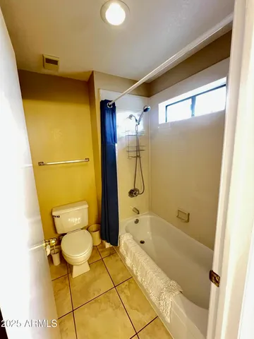 a bathroom with a tub and toilet