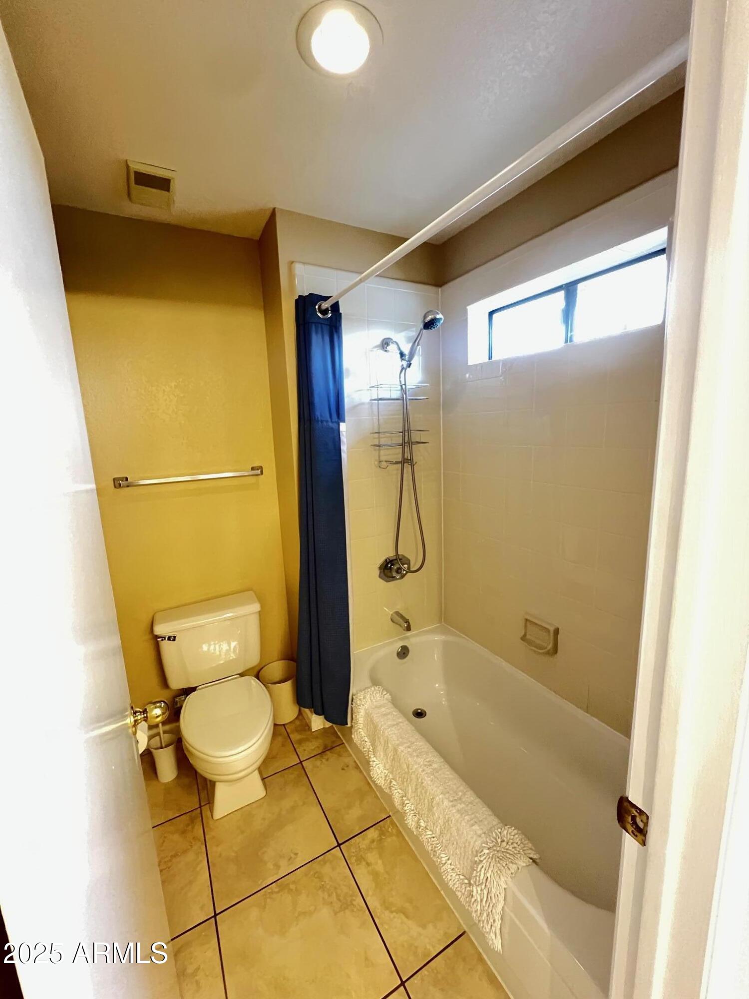 5518 East Lindstrom Lane, Unit 2020 Mesa, AZ 85215 - Photo 19 of 35 a bathroom with a tub and toilet