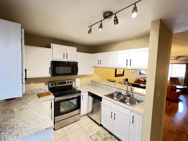 a kitchen with a stove and a white cabinets