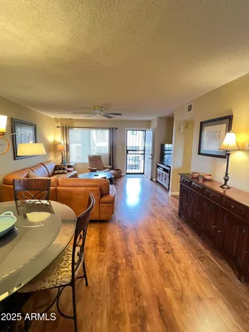 a living room with furniture and a wooden floor