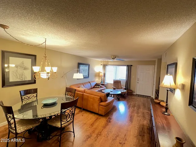 a living room with furniture and a chandelier